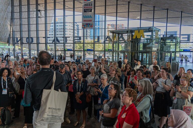 An image of a gathering of a group of people with books