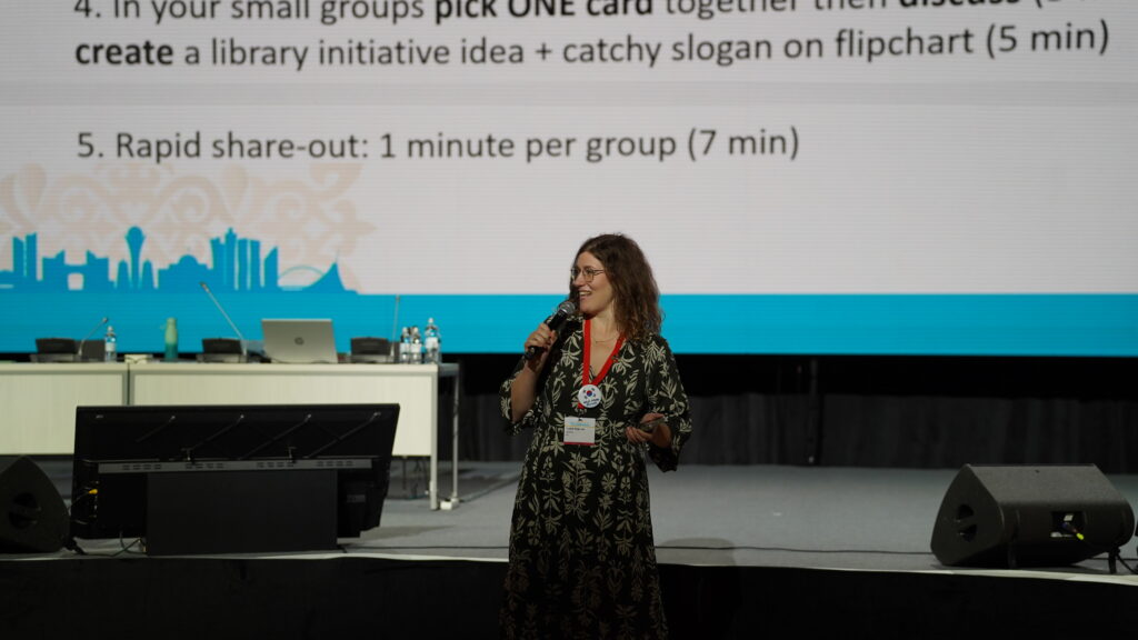 An image of a person standing and holding a microphone