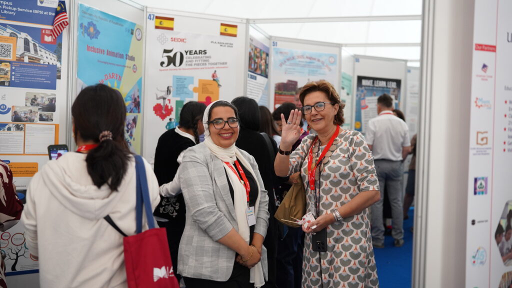 An image of two people standing in a crowd posing