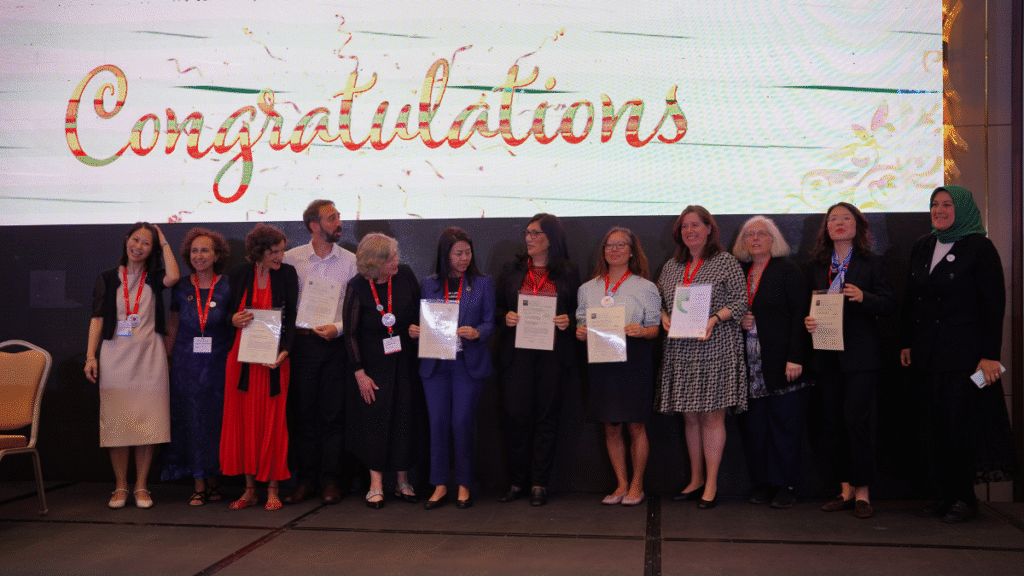 A group of people standing posing for a picture